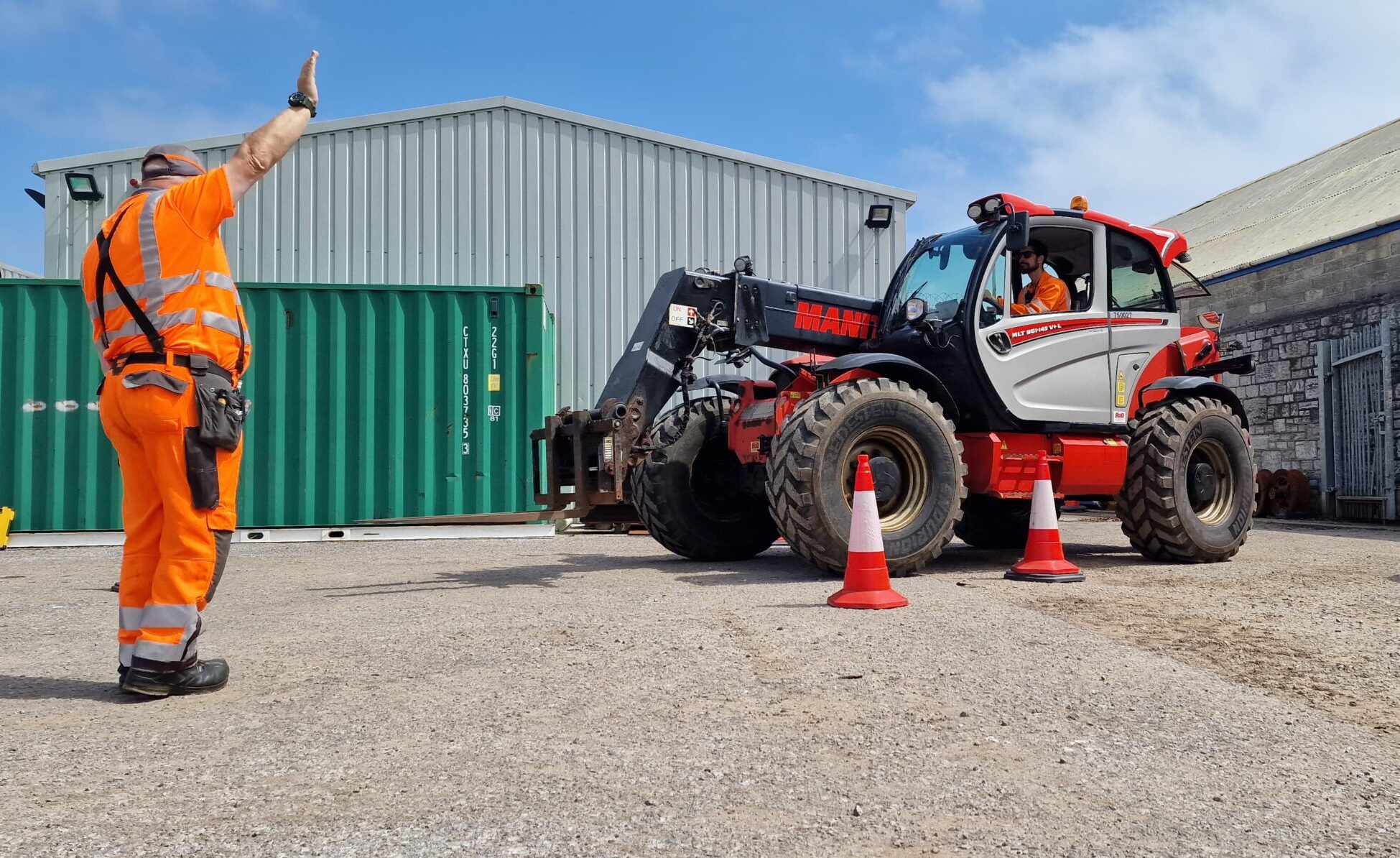 telehandler driver being guided by a banksman